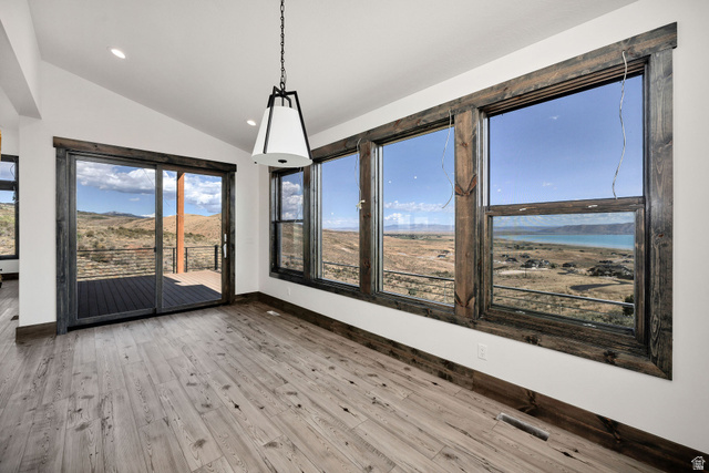 300 Knoll Loop, Unit 227 Fish Haven, ID 83287 - Photo 10 of 56 Unfurnished dining area with lofted ceiling, light wood-style flooring, a mountain view, and recessed lighting