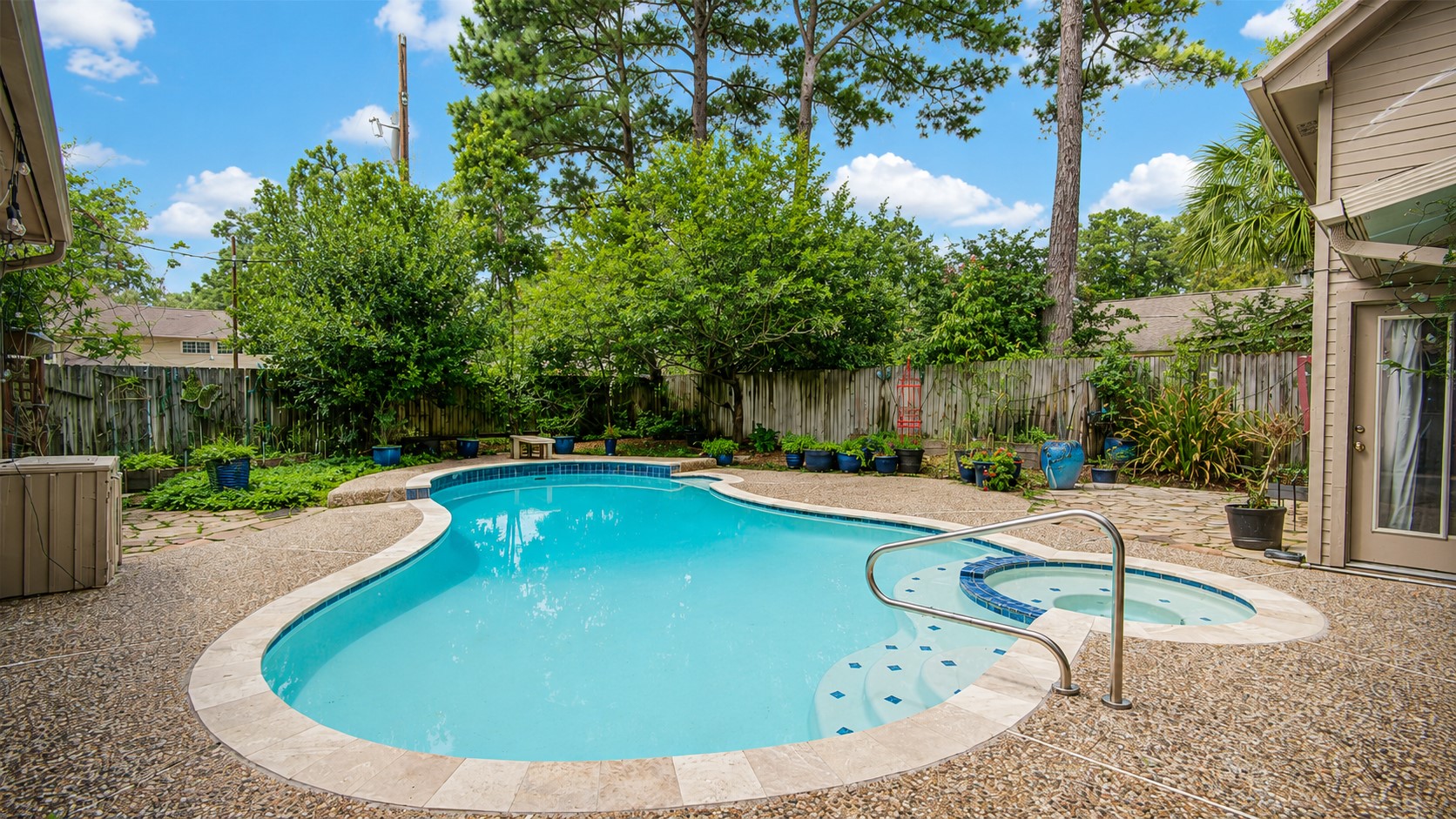 8412 Hidden Trail Lane Spring, TX 77379 - Photo 32 of 43 The private backyard retreat features a sparkling pool surrounded by mature trees, creating a peaceful setting for relaxing or entertaining.
