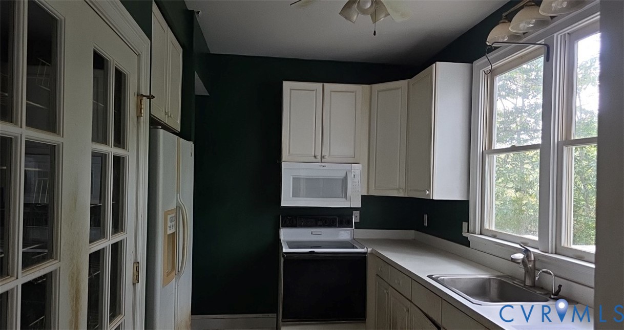235 Oak Point Drive Lancaster, VA 22503 - Photo 4 of 12 Kitchen with white appliances, plenty of natural l