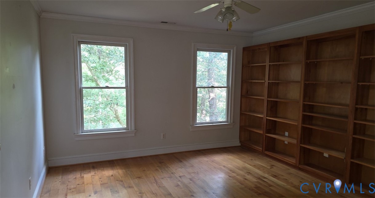 235 Oak Point Drive Lancaster, VA 22503 - Photo 9 of 12 Empty room with ornamental molding, light wood-sty