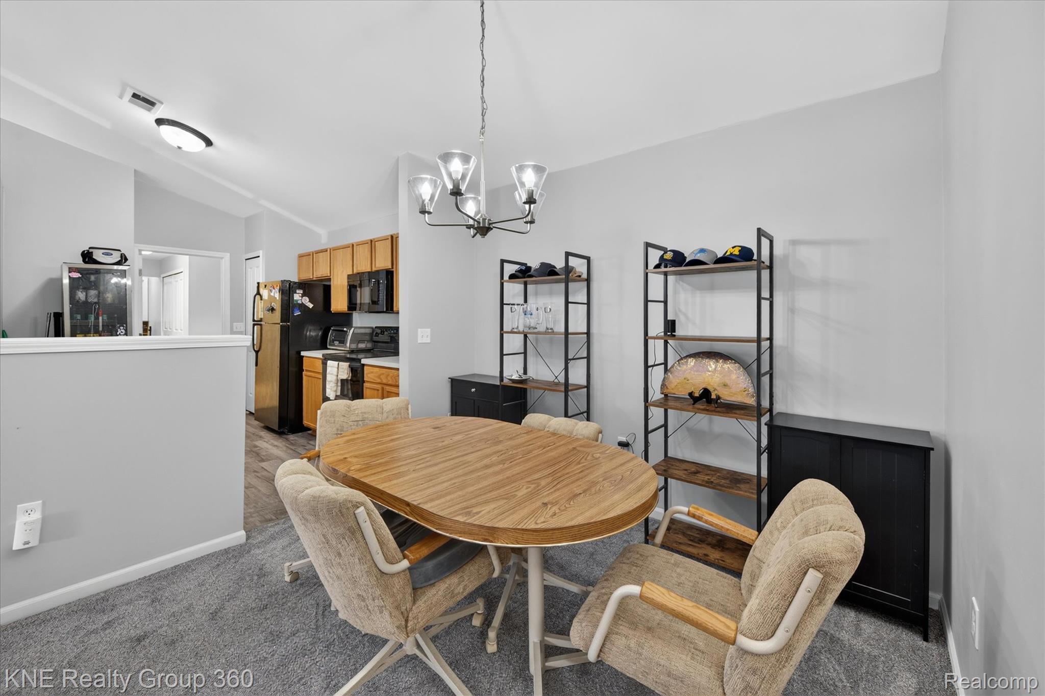 4077 Berkeley Avenue Canton, MI 48188 - Photo 10 of 32 Dining area featuring a contemporary chandelier, gray wall paint, and gray carpeting