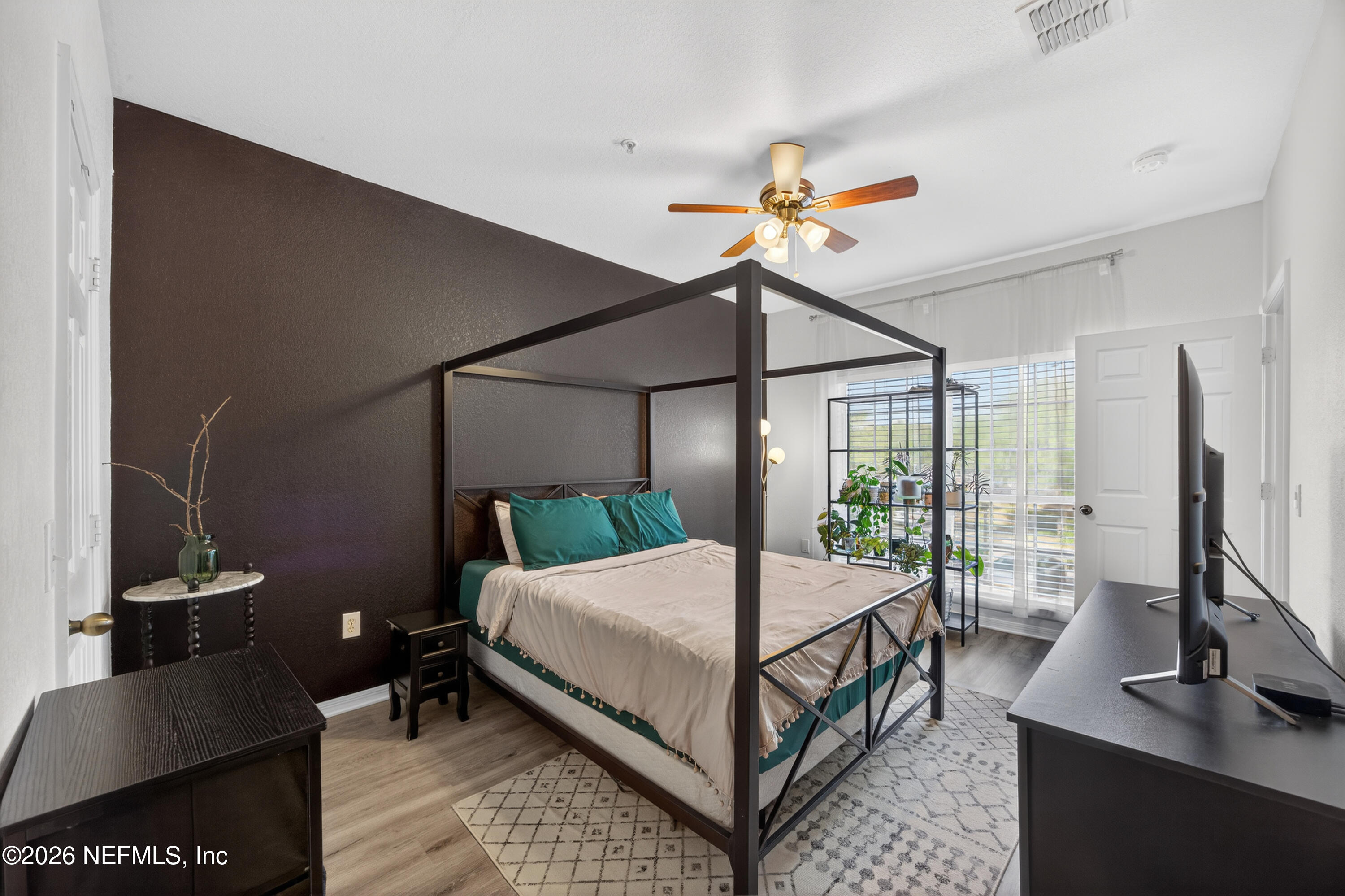 10961 Burnt Mill Road, Unit 1524 Jacksonville, FL 32256 - Photo 13 of 38 a bedroom with a bed and a flat tv screen on the dresser