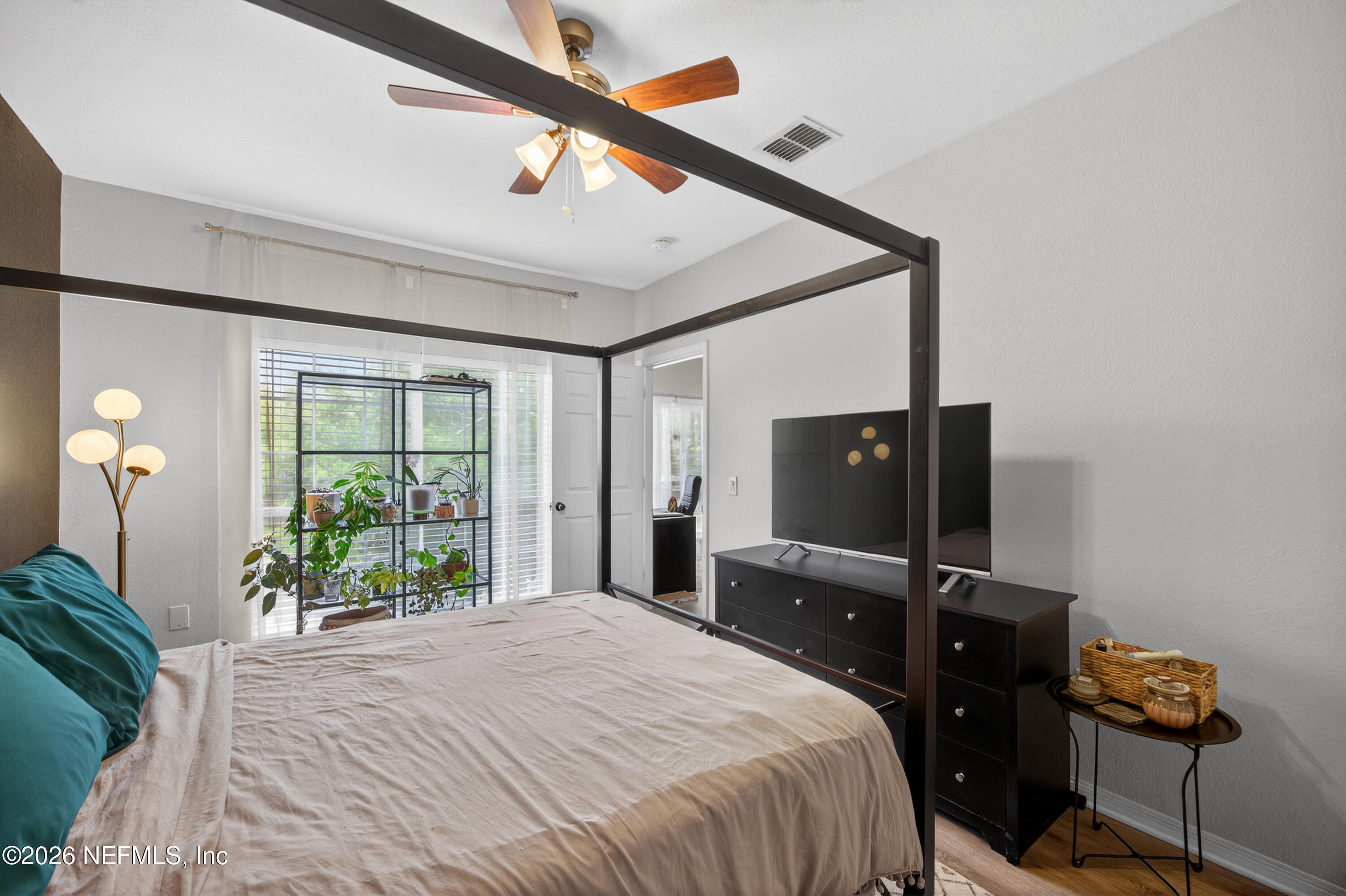 10961 Burnt Mill Road, Unit 1524 Jacksonville, FL 32256 - Photo 14 of 38 a bedroom with a bed and a television