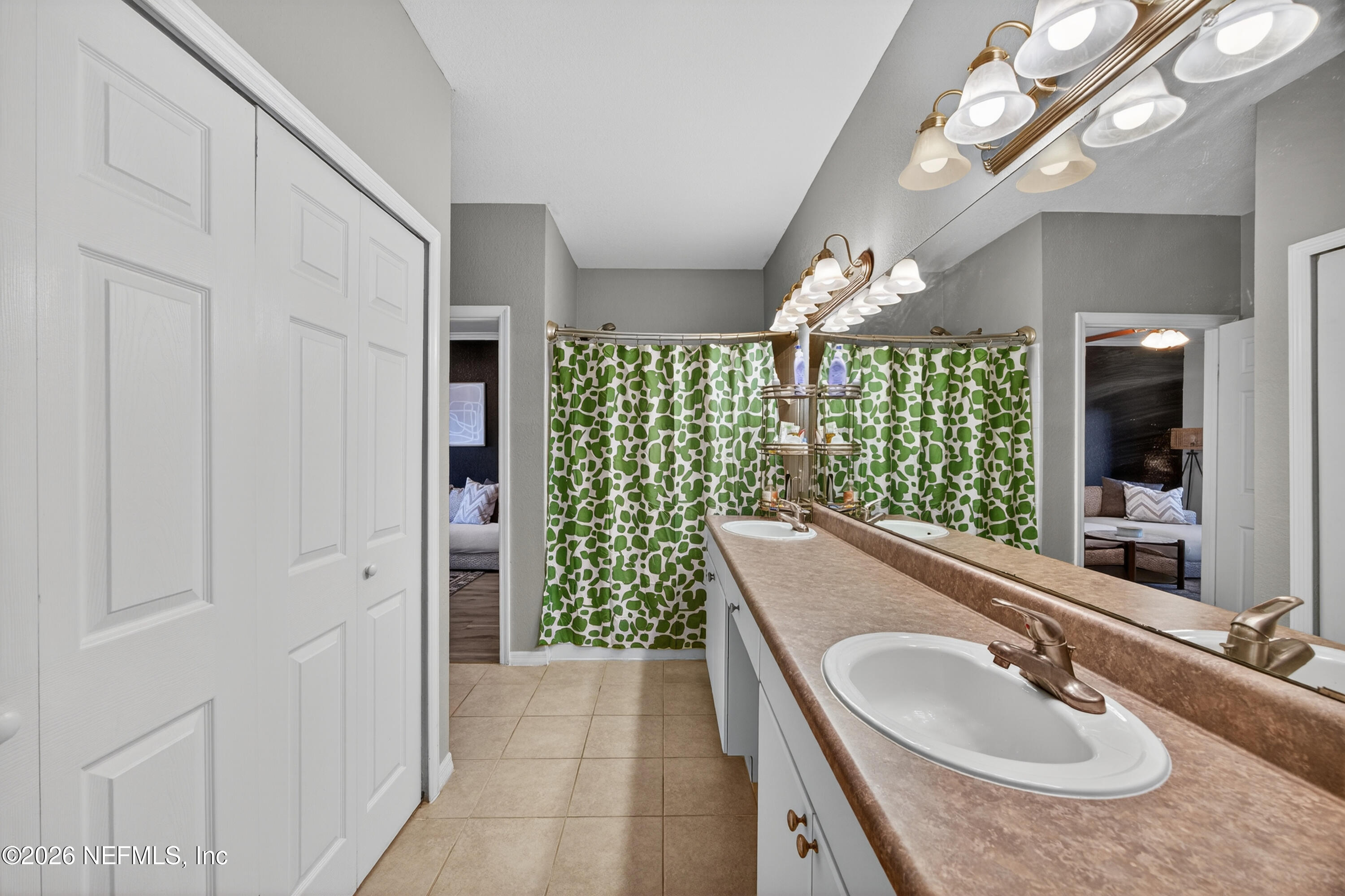 10961 Burnt Mill Road, Unit 1524 Jacksonville, FL 32256 - Photo 17 of 38 a bathroom with a sink a vanity and a mirror