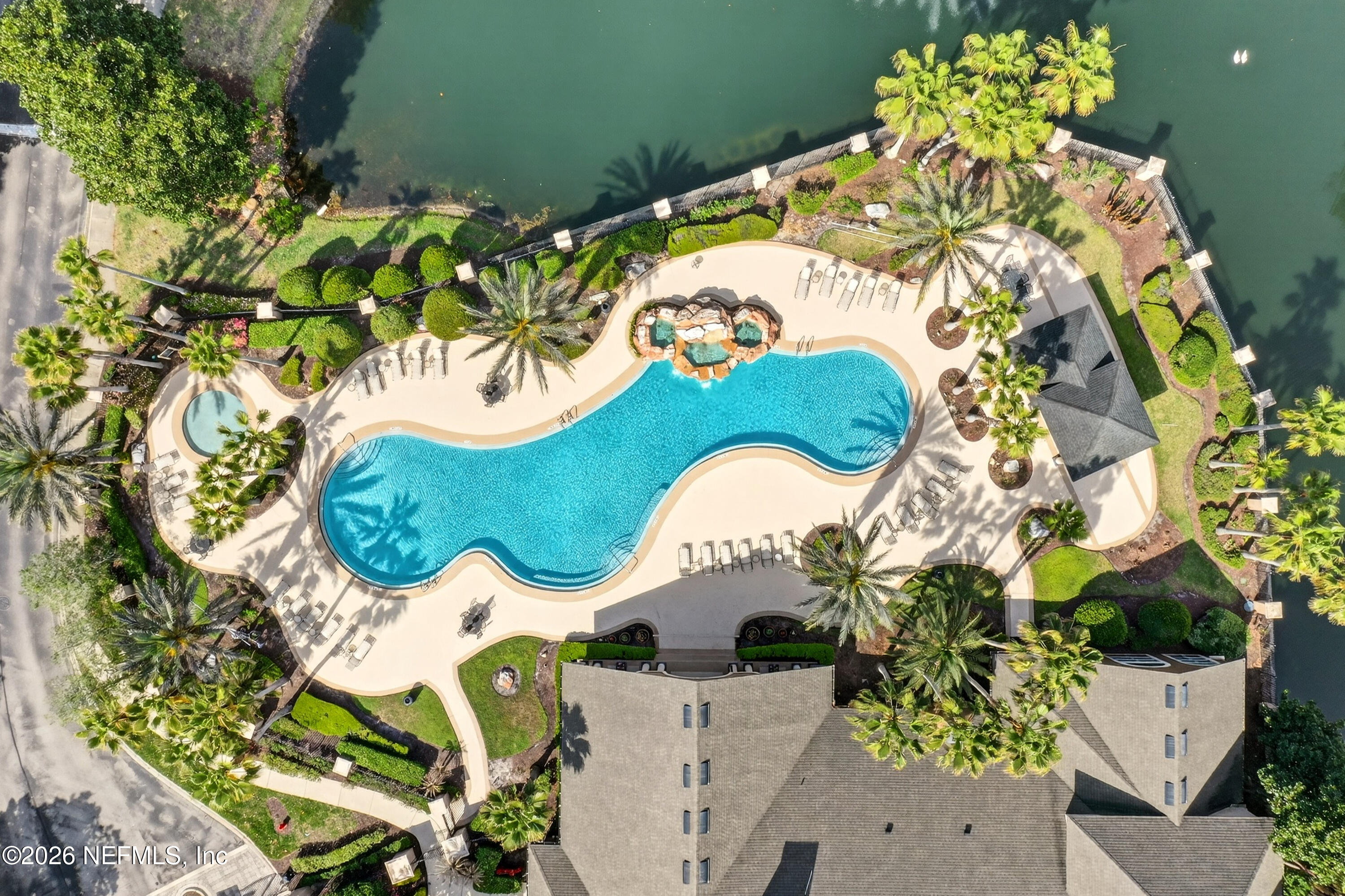10961 Burnt Mill Road, Unit 1524 Jacksonville, FL 32256 - Photo 27 of 38 an aerial view of a house with a swimming pool and a yard