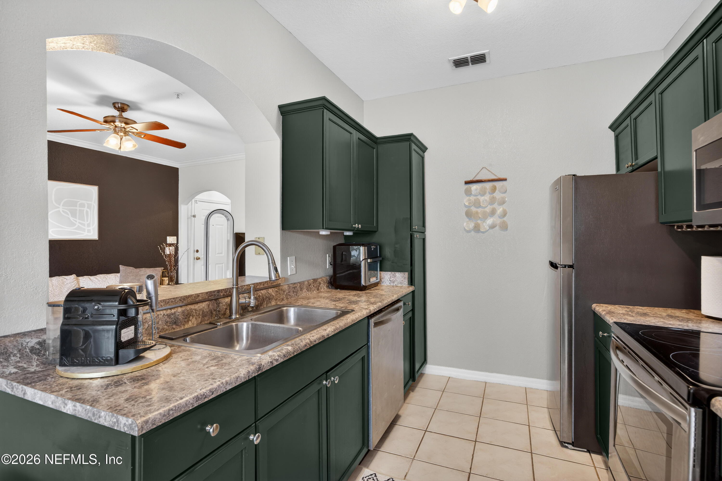 10961 Burnt Mill Road, Unit 1524 Jacksonville, FL 32256 - Photo 9 of 38 a kitchen with stainless steel appliances granite countertop a sink stove and refrigerator