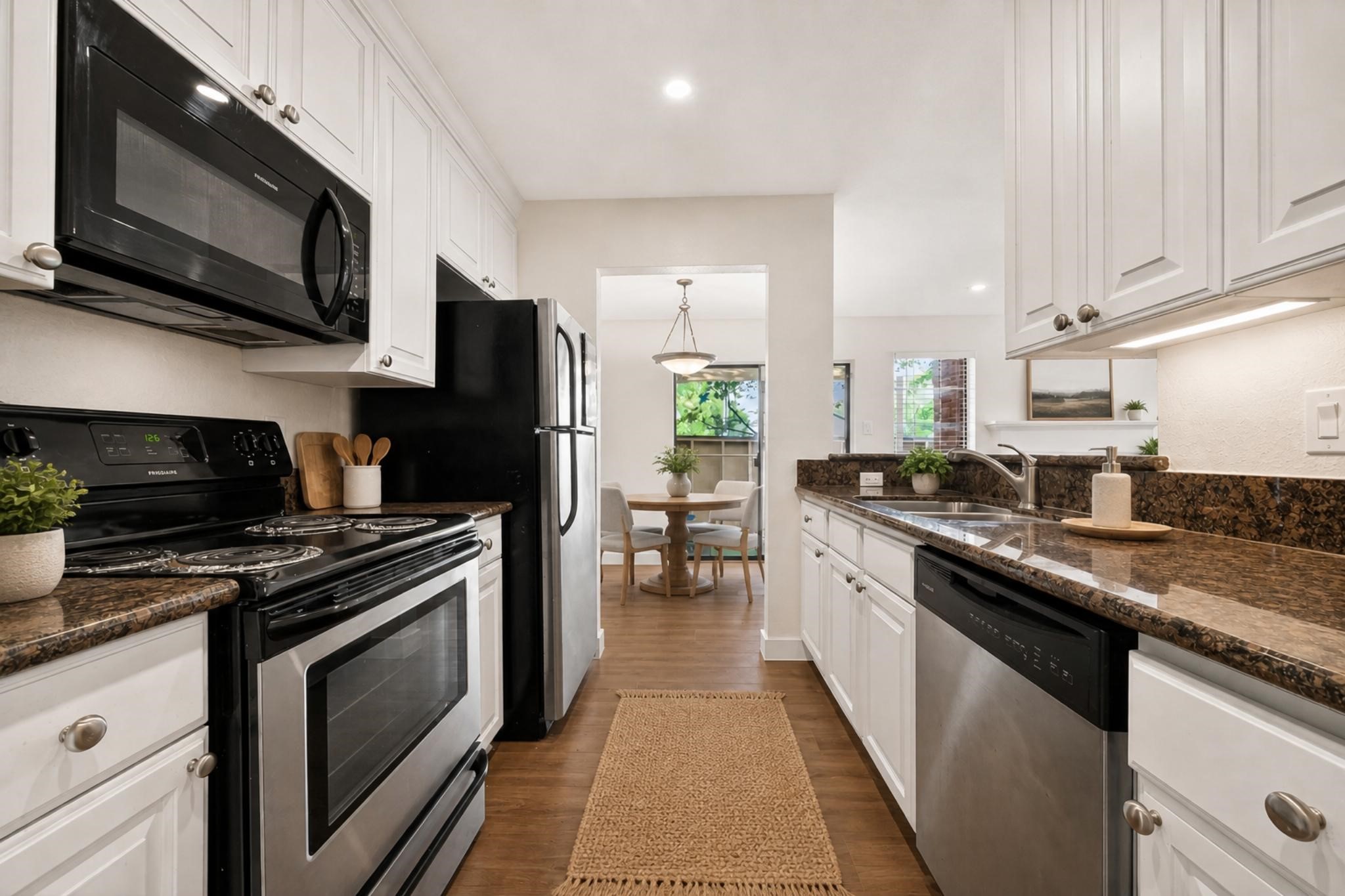 2211 South Kirkwood Road, Unit 68 Houston, TX 77077 - Photo 6 of 14 “Bright, updated kitchen featuring granite countertops, white cabinetry, stainless steel appliances, and a clean, modern look.”