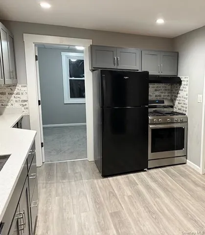 a kitchen with a refrigerator and a sink
