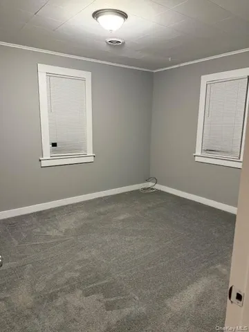 an empty room with windows and closet