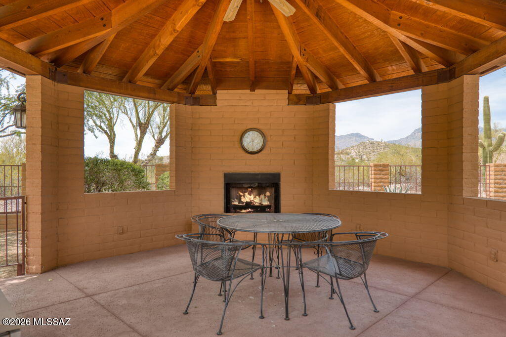 3575 North Pantano Road Tucson, AZ 85750 - Photo 48 of 51 Wood-burning fireplace and window views of desert and Catalina Mountains