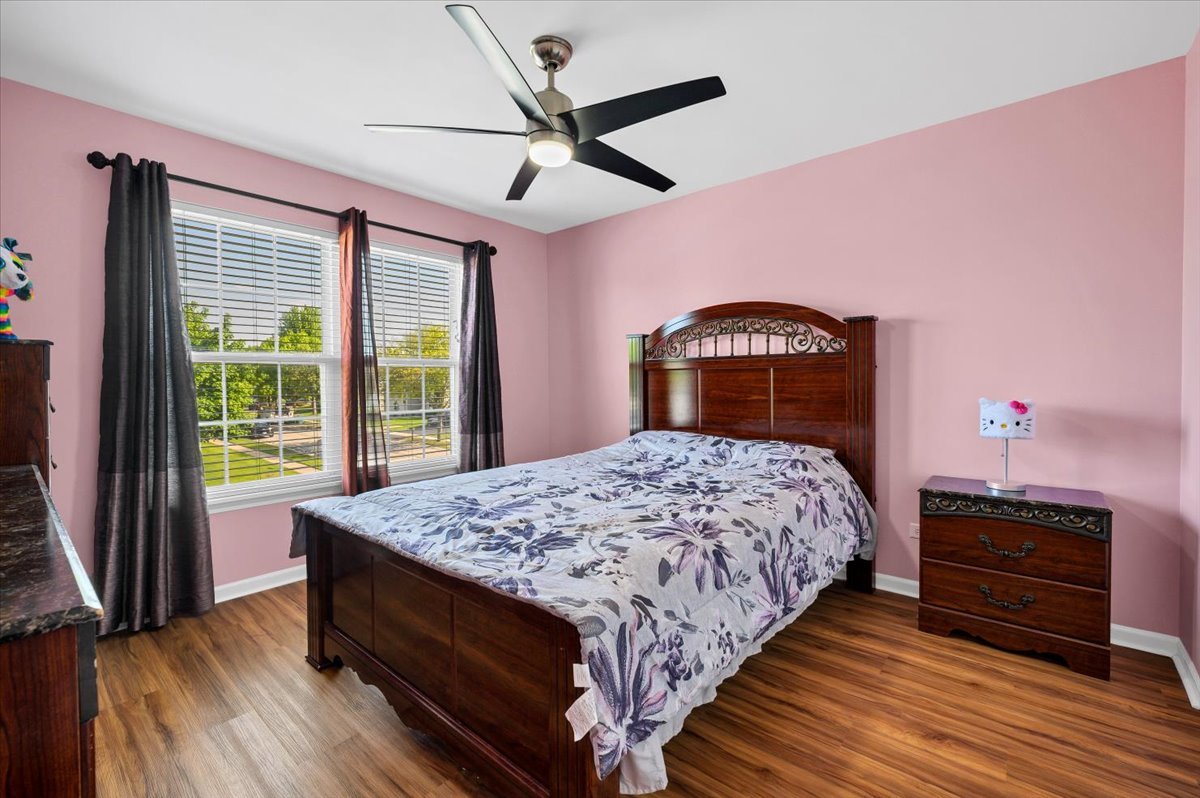 322 Zinnia Drive Romeoville, IL 60446 - Photo 20 of 42 a bedroom with a bed dresser and a large window