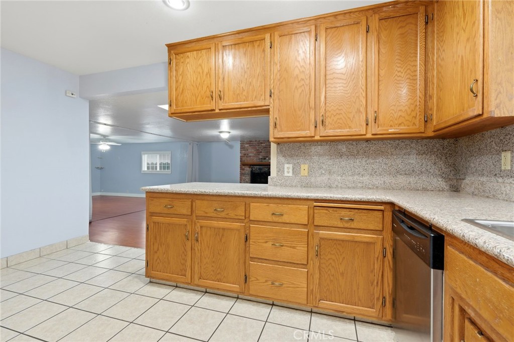 2826 East Hampton Way Fresno, CA 93726 - Photo 12 of 29 a kitchen with stainless steel appliances granite countertop a sink and cabinets