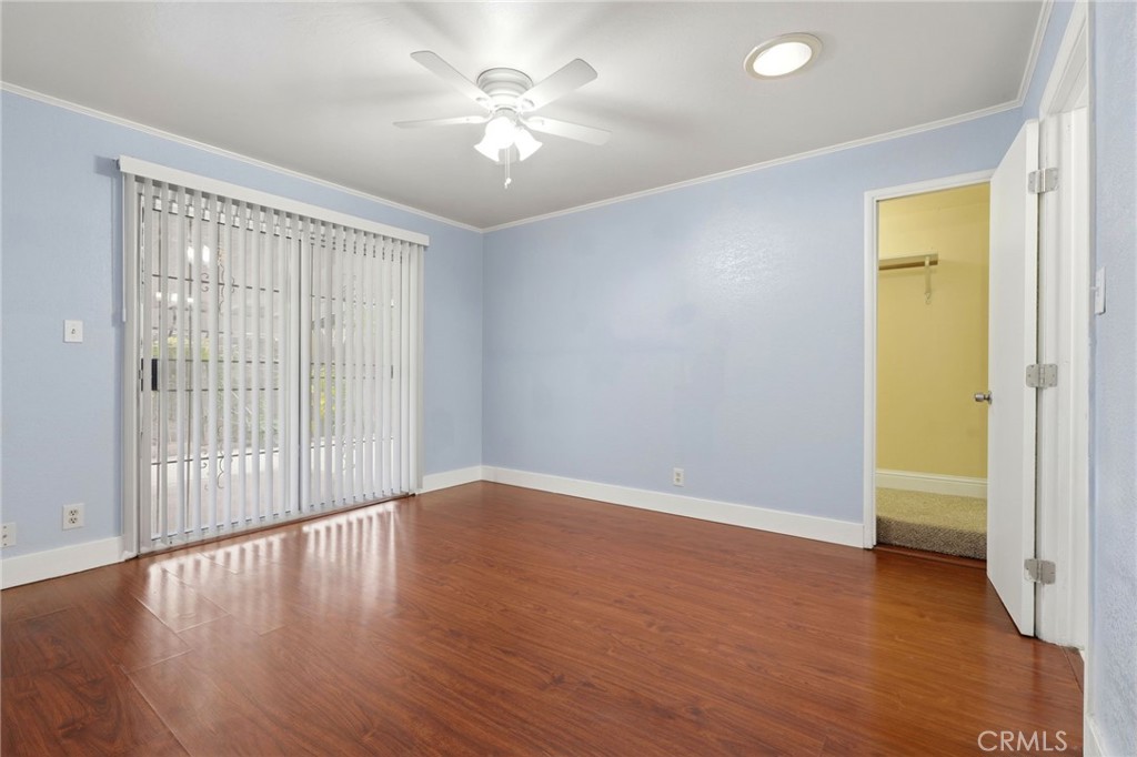 2826 East Hampton Way Fresno, CA 93726 - Photo 16 of 29 an empty room with wooden floor and windows
