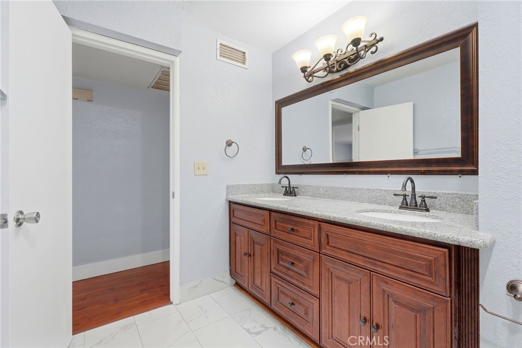 2826 East Hampton Way Fresno, CA 93726 - Photo 18 of 29 a bathroom with a double vanity sink and a mirror