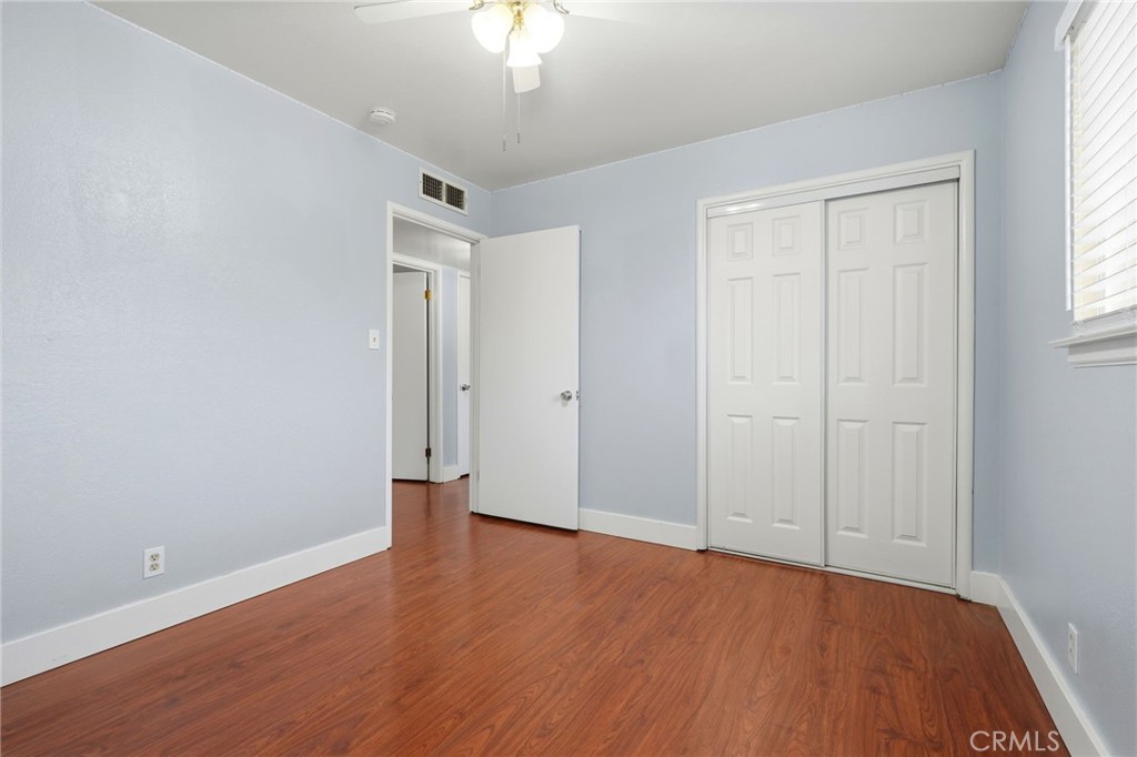 2826 East Hampton Way Fresno, CA 93726 - Photo 19 of 29 an empty room with wooden floor and windows