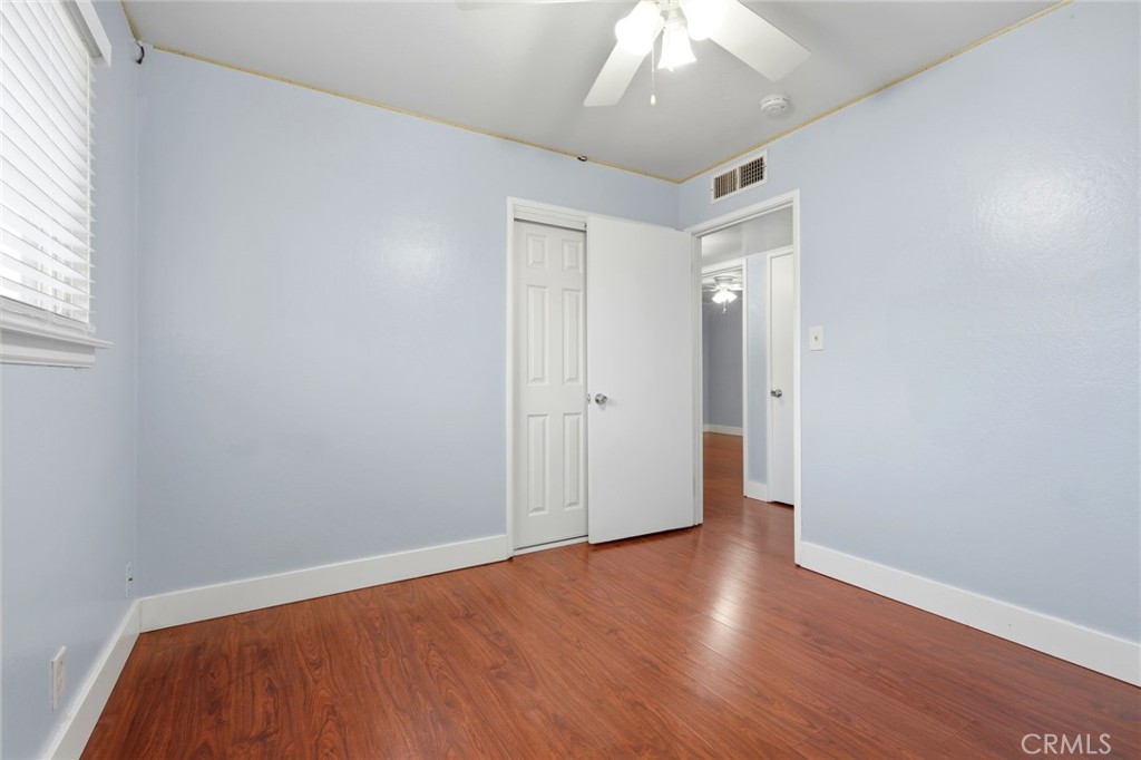 2826 East Hampton Way Fresno, CA 93726 - Photo 20 of 29 an empty room with wooden floor and windows