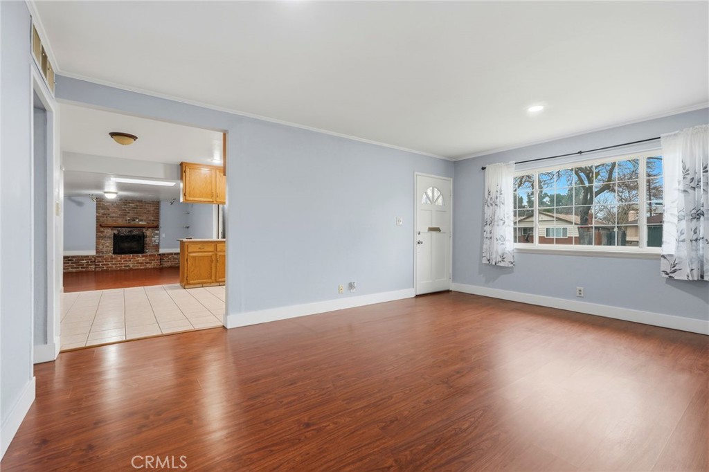2826 East Hampton Way Fresno, CA 93726 - Photo 6 of 29 a view of a room with wooden floor and a window