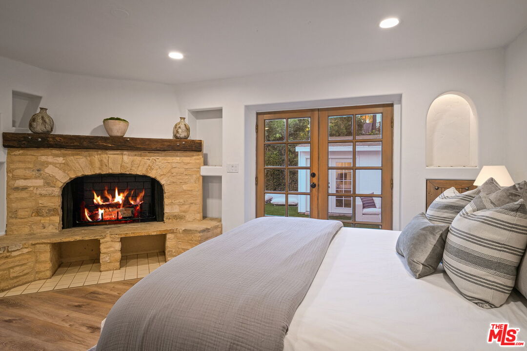 543 Westmount Drive West Hollywood, CA 90048 - Photo 15 of 44 a bedroom with a bed and a fireplace