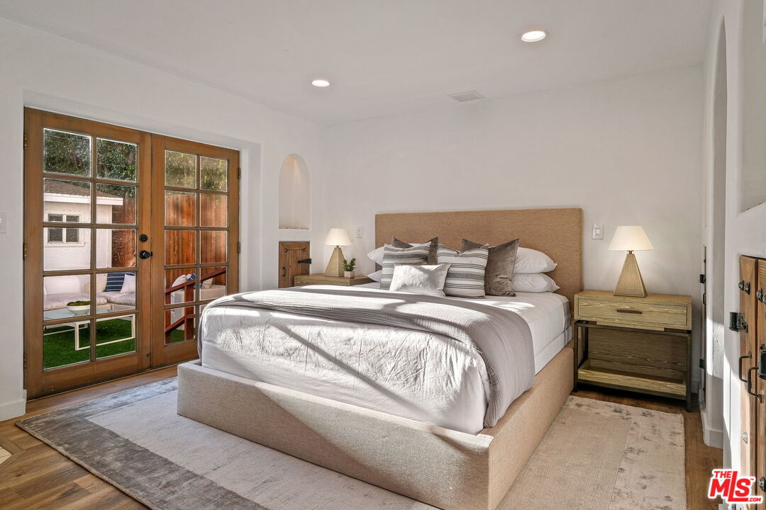 543 Westmount Drive West Hollywood, CA 90048 - Photo 17 of 44 a bed room with a bed and a large window