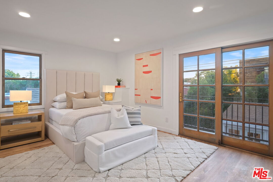 543 Westmount Drive West Hollywood, CA 90048 - Photo 24 of 44 a bedroom with furniture and a large window