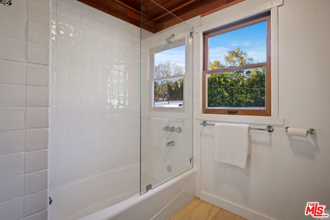 543 Westmount Drive West Hollywood, CA 90048 - Photo 25 of 44 a bathroom with a bathtub and a shower