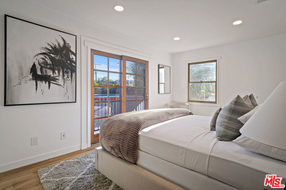 543 Westmount Drive West Hollywood, CA 90048 - Photo 27 of 44 a living room with a bed furniture and a window