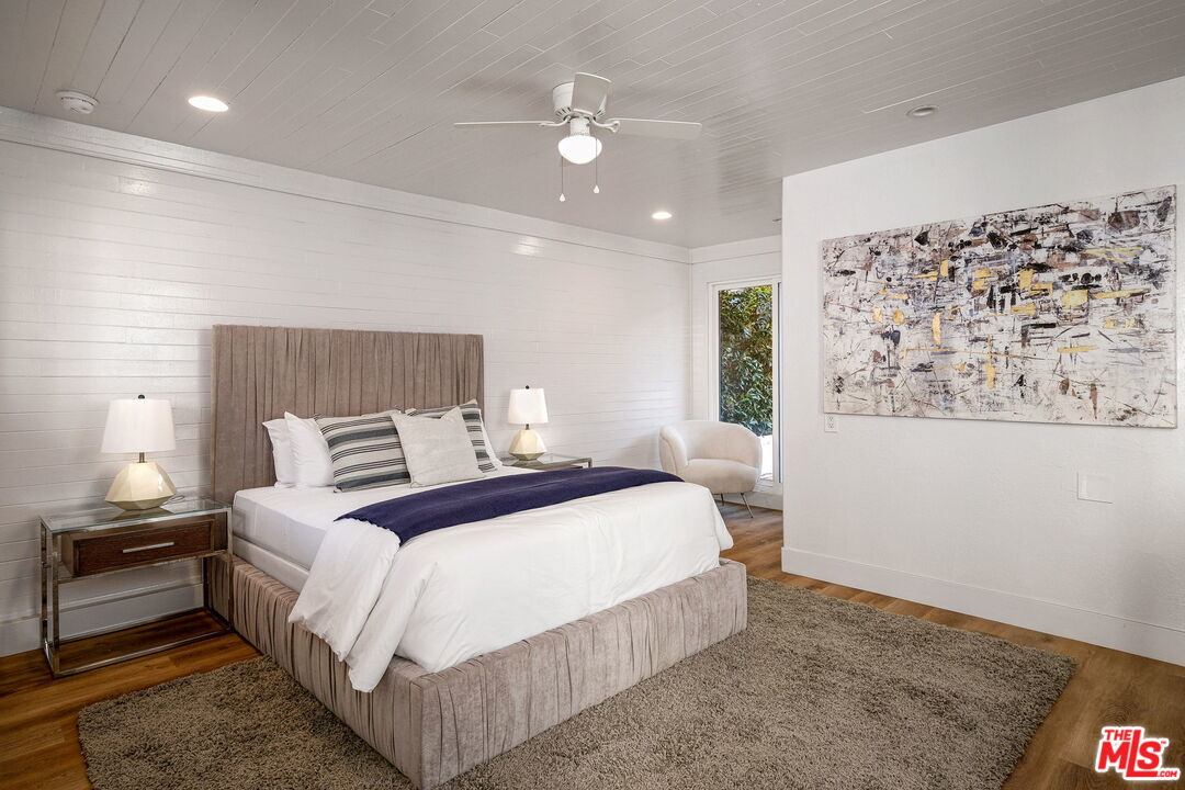 543 Westmount Drive West Hollywood, CA 90048 - Photo 33 of 44 a bedroom with a large bed and a chandelier