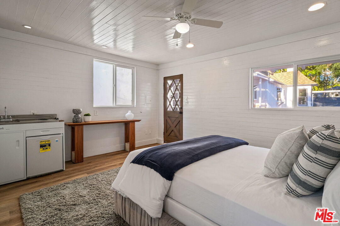 543 Westmount Drive West Hollywood, CA 90048 - Photo 34 of 44 a bedroom with a bed and a chandelier