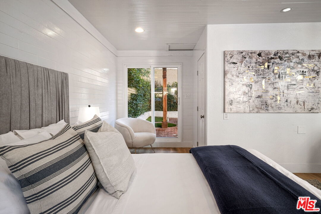 543 Westmount Drive West Hollywood, CA 90048 - Photo 35 of 44 a bedroom with furniture and a large window