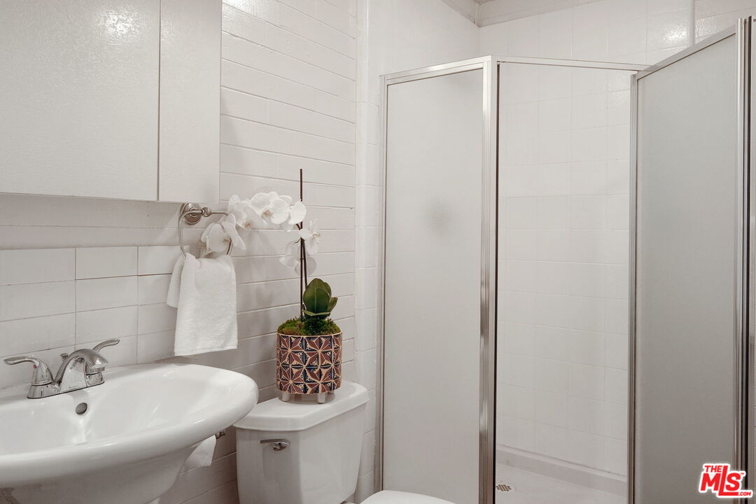 543 Westmount Drive West Hollywood, CA 90048 - Photo 37 of 44 a bathroom with a sink toilet and shower
