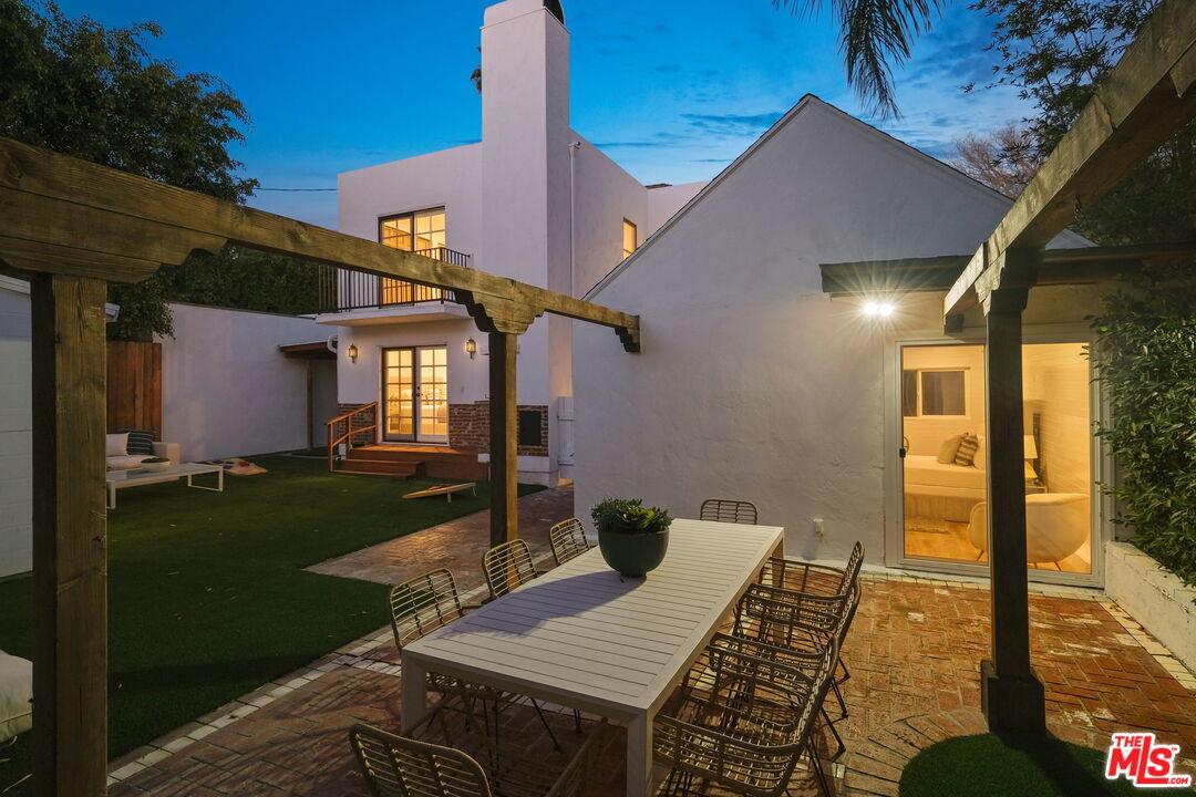543 Westmount Drive West Hollywood, CA 90048 - Photo 42 of 44 a view of a patio with table and chairs with wooden floor and fence