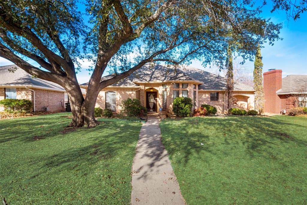 213 Pear Tree Place Denton, TX 76207 - Photo 1 of 1 a front view of a house with a garden