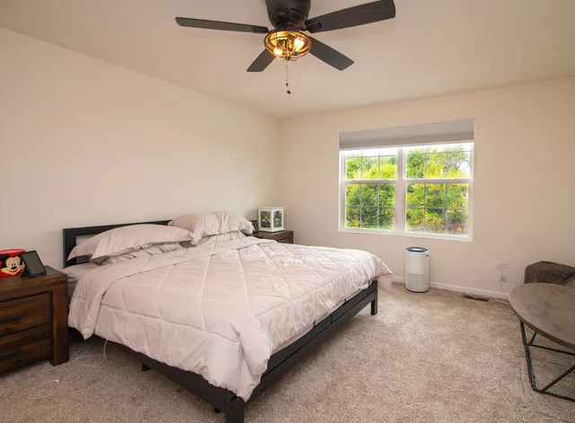 a bedroom with a bed and window