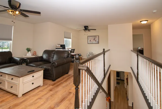 a living room with furniture and a chandelier