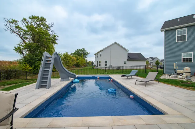 swimming pool view with a outdoor seating