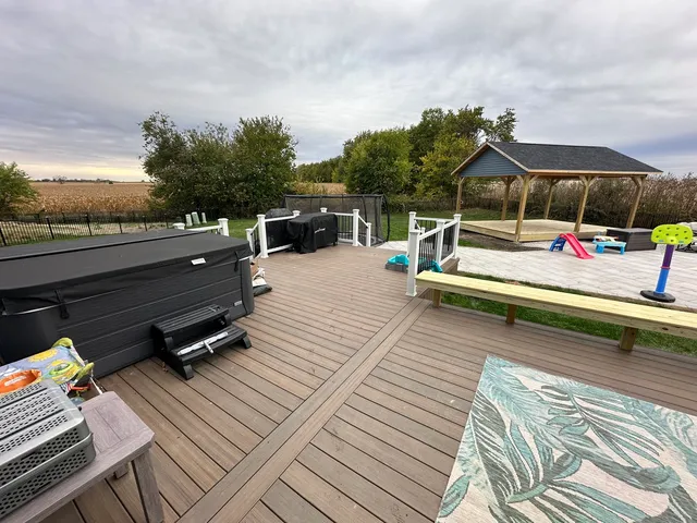 a view of roof deck with wooden floor and seating space