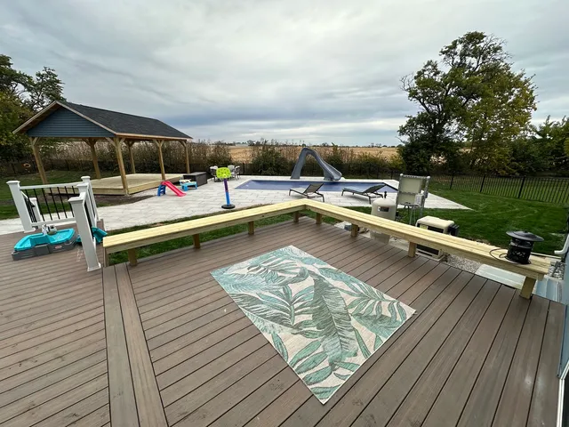 a view of swimming pool with lounge chair and couches