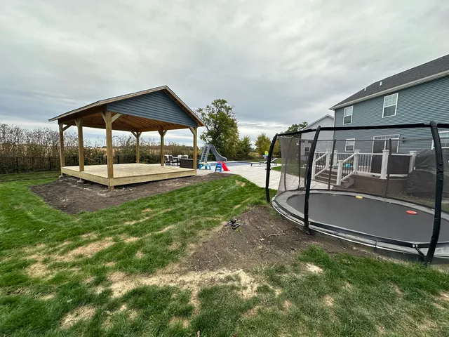 a view of a house with backyard and sitting area