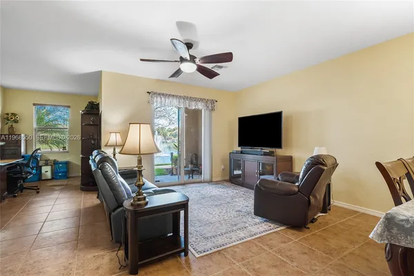 a living room with furniture and a baby crib