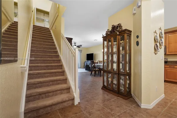 a view of entryway and hall with wooden floor