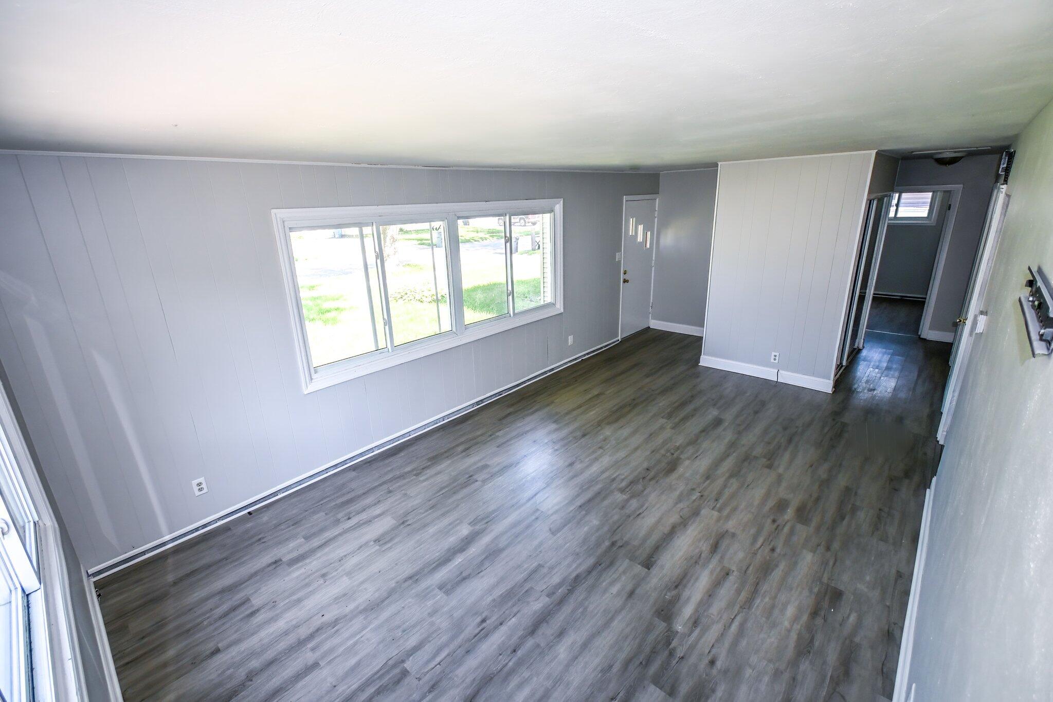 7828 Chestnut Avenue Hammond, IN 46324 - Photo 7 of 23 an empty room with wooden floor and windows