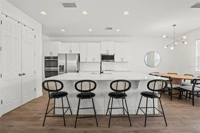 a kitchen with stainless steel appliances a sink stove and cabinets