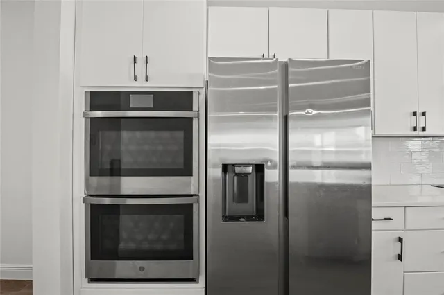a view of walk in closet with wooden floor