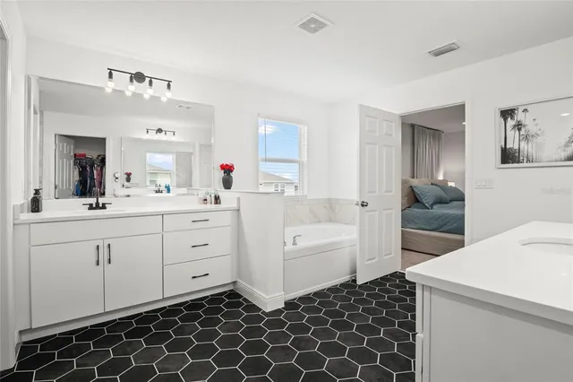 a bathroom with a double vanity sink and a mirror