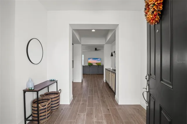 a view of a hallway with wooden floor