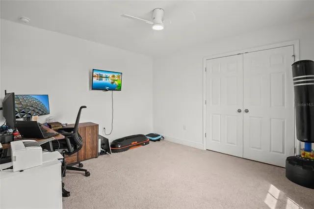 an aerial view of residential houses with outdoor space and parking