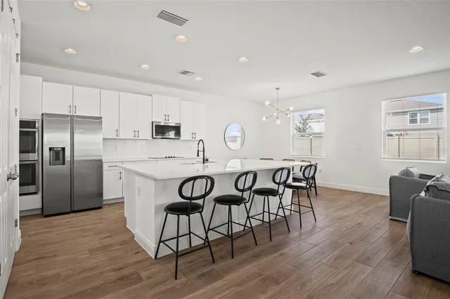 a view of a dining room with furniture and a window