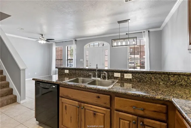 a kitchen with granite countertop a sink and cabinets