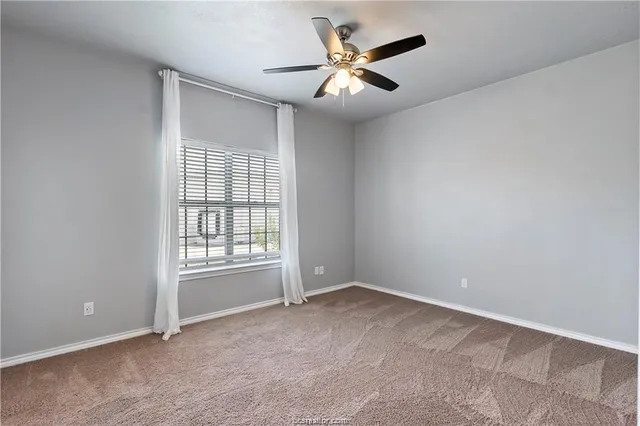 an empty room with a empty space and a ceiling fan