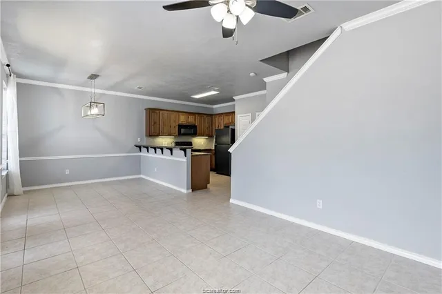 a view of an empty room with kitchen